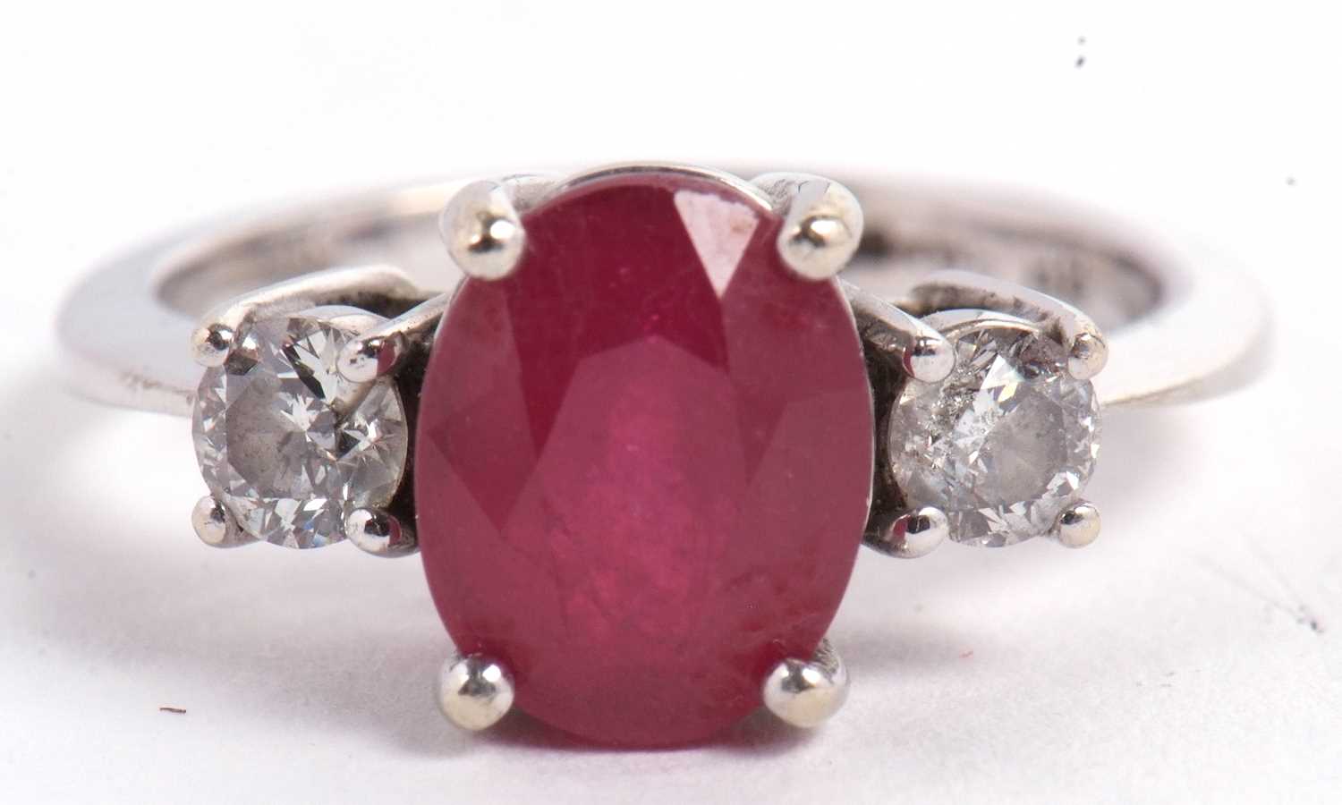 A 14ct white gold ruby and diamond ring, the oval mixed cut ruby, approx. 9.1 x 7.1 x 5.1mm, set