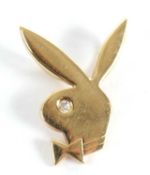 An 18ct playboy bunny pendant with small diamond set eye, double hanging loop to reverse, stamped
