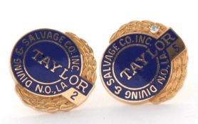 A pair of 14k dress studs, with branded blue enamel fronts, one with a small round diamond highlight