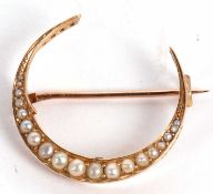 A late Victorian 15ct split pearl crescent brooch, set with graduated split pearls, stamped 15 and