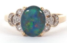 A 9k opal triplet and diamond ring, the oval opal triplet, claw mounted with diamond set shoulders