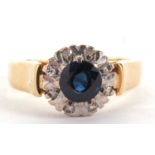 An 18ct sapphire and diamond ring, the central round sapphire surrounded by illusion set diamonds,