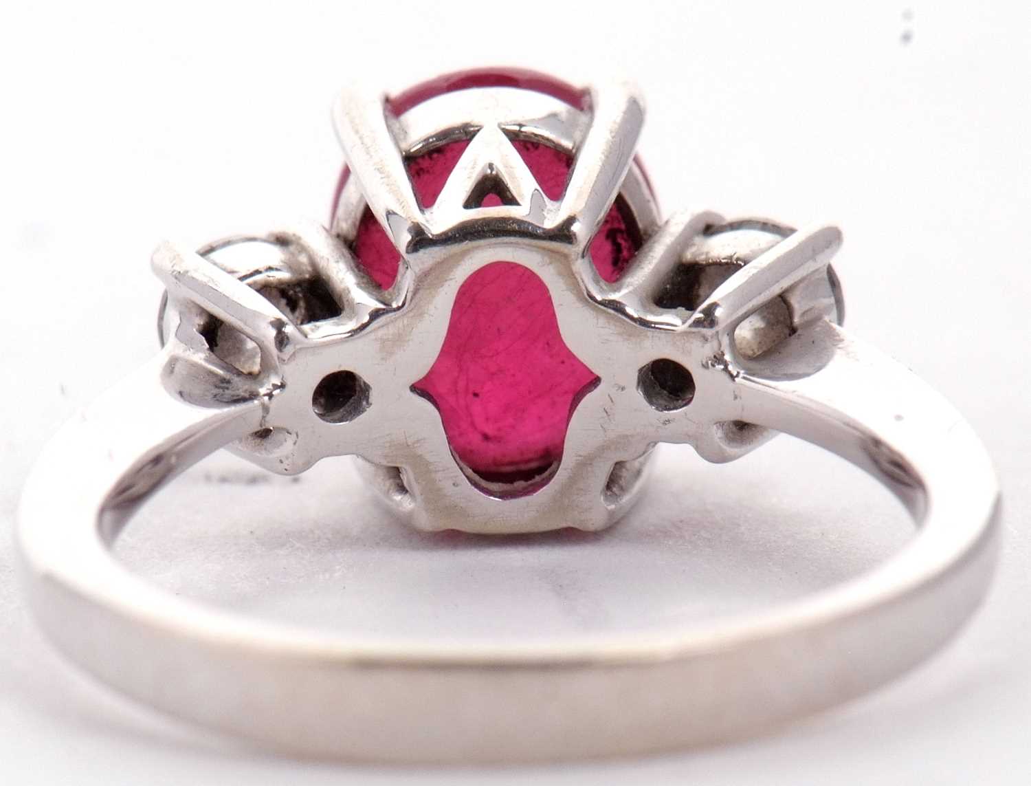 A 14ct white gold ruby and diamond ring, the oval mixed cut ruby, approx. 9.1 x 7.1 x 5.1mm, set - Image 5 of 10