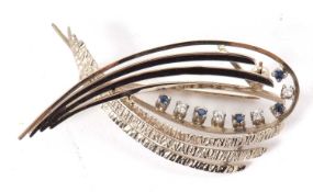A 14ct sapphire and diamond brooch, with arched strands with satin and textured finish set with