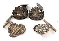 Two pairs of silver cufflinks by Malcolm Appleby: the first depicting an octopus with a central eye,