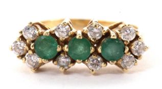 A 14ct emerald and white stone ring, the three round emeralds interspaced with a single round