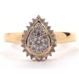 A 9ct pear shape diamond cluster ring, the centre pave set with a yellow gold surround, followed