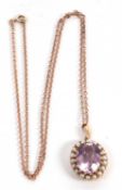 An amethyst and cultured pearl pendant, the oval amethyst with a surround of small cultured