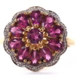 A 9ct pink gemstone and diamond highlight cluster ring, comprised of a single round pink gemstone