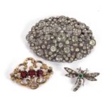 Three brooches: to include an unmarked three stone garnet and yellow metal brooch, (tests as approx.