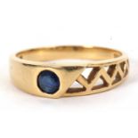 An 18k sapphire ring, the round sapphire set within a tapering band with triangular pierced