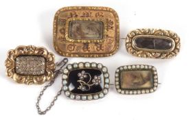 Five memorial brooches, to include a black enamel and split and seed pearl brooch with hairwork