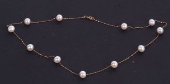 A 14 cultured pearl necklace, the round cultured pearls separated by short lengths of gold chain,
