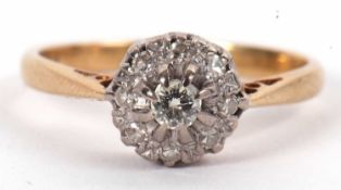 A diamond cluster ring, the central round brilliant cut diamond surrounded by small round single cut