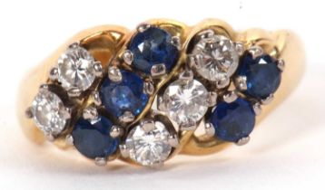 An 18ct sapphire and diamond ring, the four alternating rows of round sapphires and diamonds, set at
