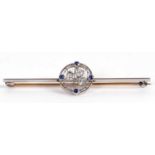 A sapphire and diamond bar brooch, the central round disc set with a three leave clover on a frame