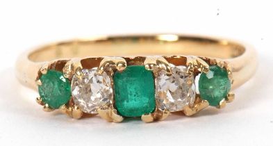 An 18ct five stone emerald and diamond ring, set with an emerald cut emerald to centre, old mine cut
