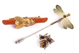 Three insect brooches: to include an enamelled dragonfly stick pin, a faux amber and gilt metal