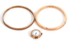 Two 9ct bangles and a 9ct cased wristwatch, the two upper arm bangles, both stamped 9ct, (27.0g),