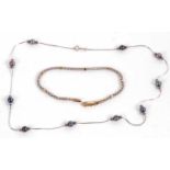 A 9ct white gold and black pearl necklace, the fine link chain set with round black pearls with a