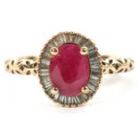 A 9ct ruby and diamond ring, the oval mixed cut ruby in a four claw mount, surrounded by tapered