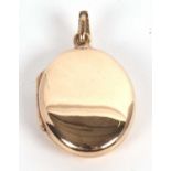 A plain oval 9ct locket, 25mm long, with tapered bale, hallmarked to reverse Birmingham 1990, 7.5g