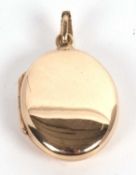 A plain oval 9ct locket, 25mm long, with tapered bale, hallmarked to reverse Birmingham 1990, 7.5g