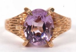 A 9ct pale amethyst ring, the oval mixed cut amethyst in a raised six claw mount, with textured