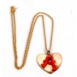 A coral decorated heart pendant and 9ct chain, the heart pendant set with a coral 'A', 3cm wide,