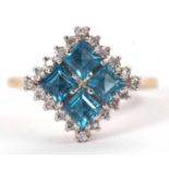 A 9ct topaz and diamond ring, the four square step cut blue topaz surrounded by small round