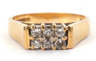 An 18ct diamond ring, set with six small round diamonds, with 5mm wide tapered shoulder and plain