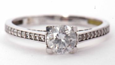 A 9ct white gold and CZ ring, the central round CZ with white stone set shoulders, plain lower