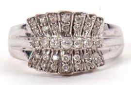 A 9ct white gold and diamond ring, set with a central row of slightly graudated round brilliant