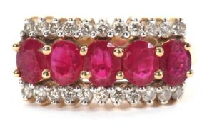 An 18ct ruby and diamond ring, set with five oval rubies with a row of small round brilliant cut