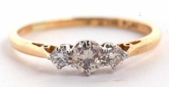 An 18ct and platinum three stone diamond ring, the three graduated round brilliant cut diamonds, set