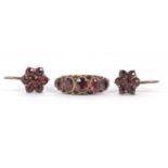 A 9ct garnet ring and similar earrings, the ring set with five graduated oval almandine garnets,