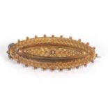 A late Victorian 15ct bar brooch, the marquise shaped brooch with raised decoration and beaded