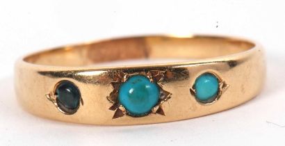 A turquoise cabochon ring, the three round graduated cabochons set in a tapered band of unmarked