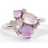 An 18ct white gold diamond, moonstone and amethyst ring, the off-set moonstone and amethyst