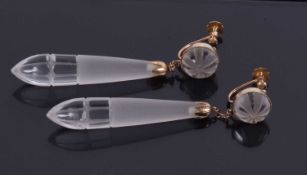 A pair of rock crystal earrings, the teardrop shaped drops with textured and polished finish, caps