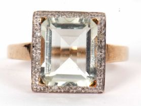 A 9ct prasiolite and diamond ring, the emerald cut prasiolite in a four claw mount, surrounded by