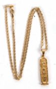 An Egyptian pendant and 18ct chain, the pendant with heiroglyphics, Egyptian marks (tests as approx.