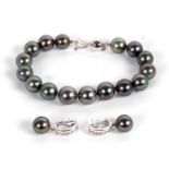 An 18ct cultured grey pearl bracelet and 18kt cultured grey pearl and diamond earrings, the bracelet