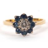 An 18ct sapphire and diamond cluster ring, the central round diamond surrounded by round