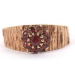 A 9ct garnet cluster ring, the raised garnet cluster set to a tapered 'bark' textured tapered