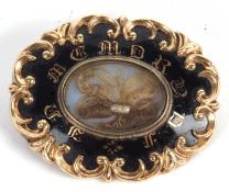 A 19th century memorial brooch, the black enamel brooch with 'In Memory' to front, with central