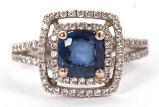 An 18ct white gold sapphire and diamond ring, the mixed cut sapphire, approx. 6.3 x 6.1 x 2.8mm in a