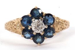 A 9ct sapphire cluster ring, the central illusion mounted diamond surrounded by round sapphires,