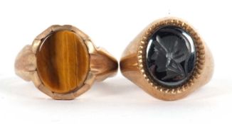 Two 9ct rings: a 9ct hematite intaglio ring, hallmarked London 1971, size J, 5.6g and a 9ct tigers