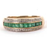 A 9ct emerald and diamond ring, the central channel of calibre cut emeralds set with a row of